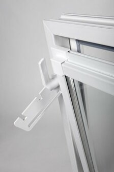 Een witte kunststof raamopening met een metalen haakje aan de zijkant, tegen een neutrale achtergrond.